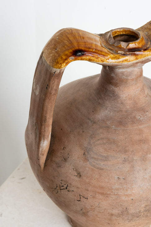 District Loom Italian terracotta amphora is an antique, hand-thrown piece with a strong body and seamlessly connected handles and spout